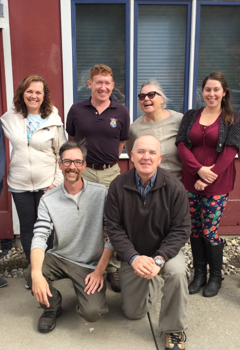 A group of 8 men and women pose for a group photo