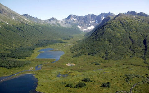 Lakes lie in a valley between two mountain ranges.