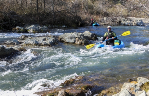 a person kayaking in rapids