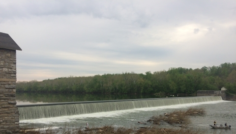 Dam along the Potomac River with a small boat in the water