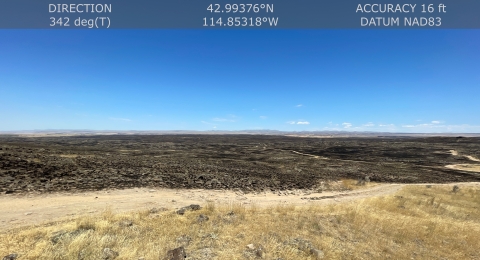Image of the aftermath of a wildfire showing scorched land