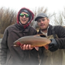 Biologists with a captured Yellowstone Cutthroat