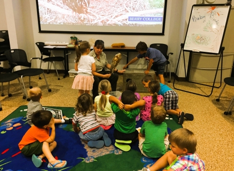 Fish and Wildlife staff conducting the Young Explorer's Club program for a group of children.