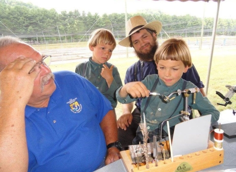 Children learning to make flies