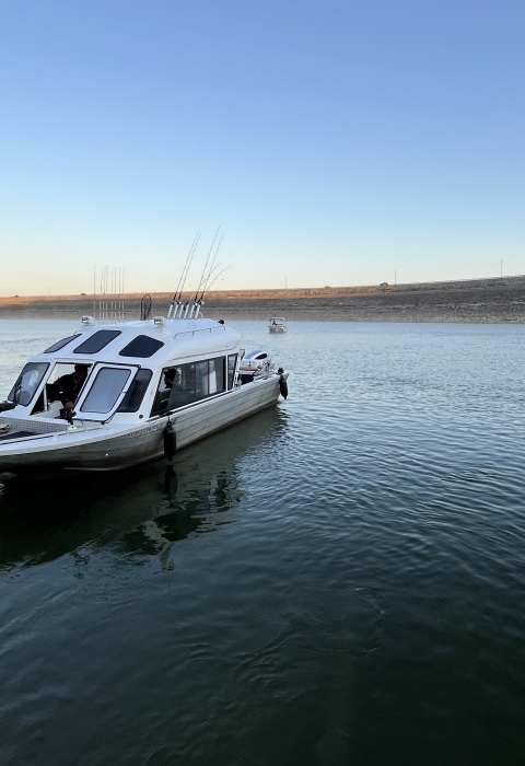 A fishing boat stationary on a lake