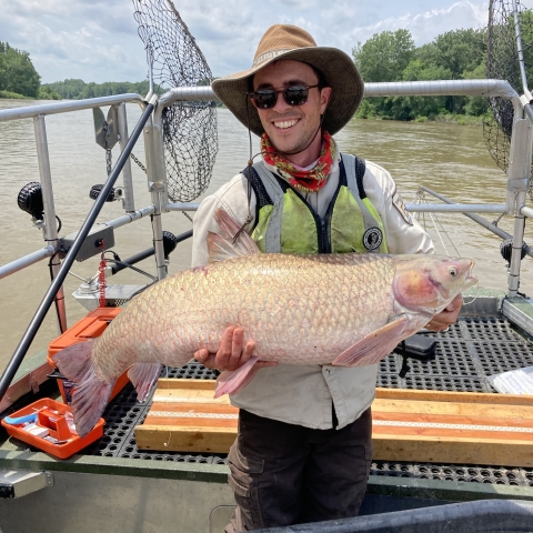 employee holding a fish