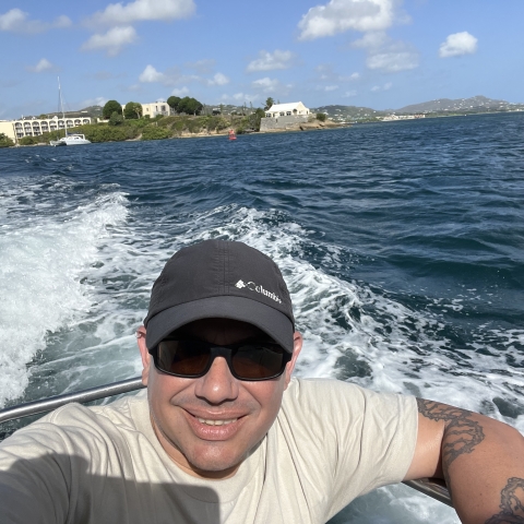 Biologist, Iván Llerandi-Román in a boat during a field visit.