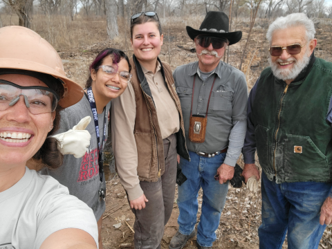 Three volunteers and two refuge staff posing after working on a trail.