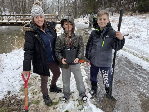 Family poses for tree planting at Cherry Valley National Wildlife Refuge