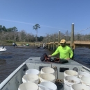 Biologist prepares boat with rock and oyster shell