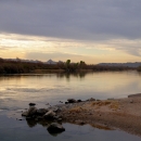 A rocky beach on the water at Havasu National Wildlife Refuge is shown.
