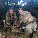 Barry Owens kneels with his grandson Daniel Verdin who harvested the 8 point buck shown in the photo.