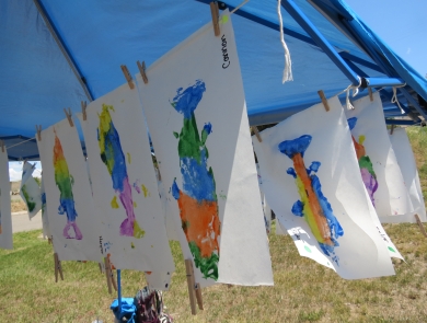 Colorful fish art hanging from a string. 