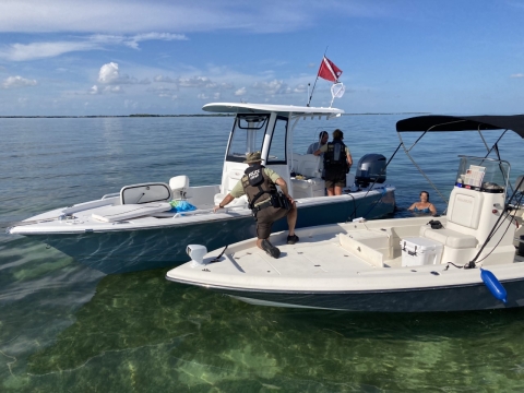 A Federal Wildlife Officer on a boat.