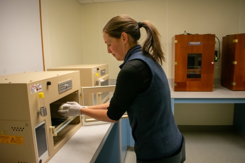 The Peregrine Fund's propagation manager Leah Esquivel putting an egg into an incubator. 
