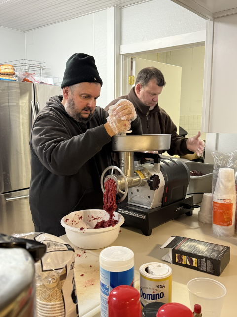 Mentors Mike (L) and George (R) process harvested meat into ground venison to be shared with program participants to take home as part of the Field to Fork mentored rifle deer hunt at Cherry Valley National Wildlife Refuge in December of 2024