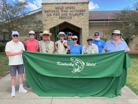 Group posing with fly fishing rods