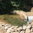 A pipe empties into a stream