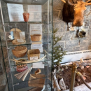 A display case containing weaved baskets.