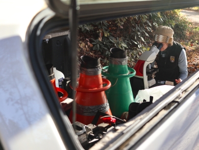 Woman at a microscope set up at at pickup truck