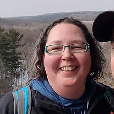 close-up photo of Pamela Skonberg with glasses and smiling.