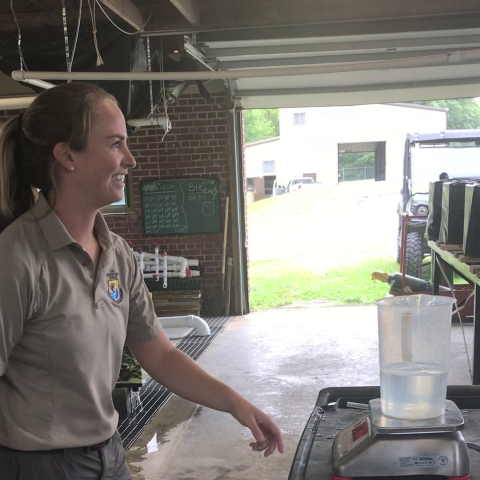 Fish Biologist, Brandi Symons with bucket, scale at Edenton NFH