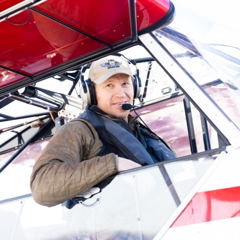 man in a cockpit of a small plane