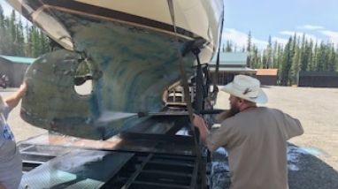 man cleans a boat