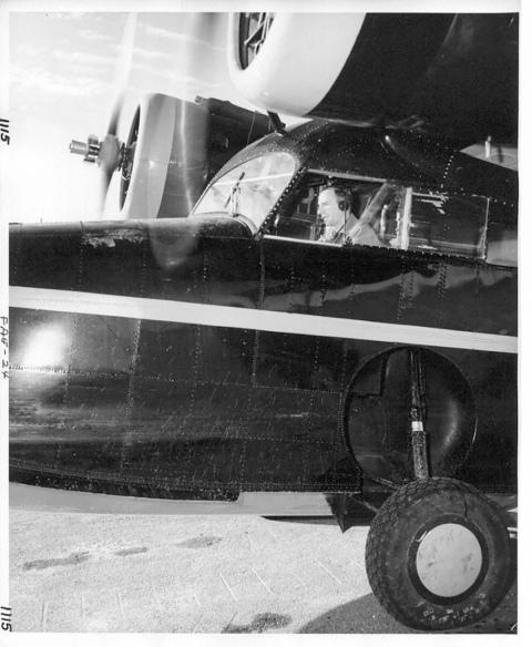 Clarence J. Rhode sits in the cockpit of a Grumman Goose, in Nome, Alaska, in 1949. E.P Haddon/USFWS.
