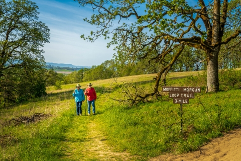 Couple walking on the trail near trail sign