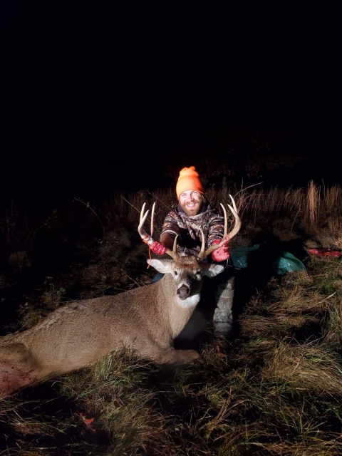 Dylan Nissley, convicted poacher and illegal guide, holding up a dead white-tailed deer buck in the field
