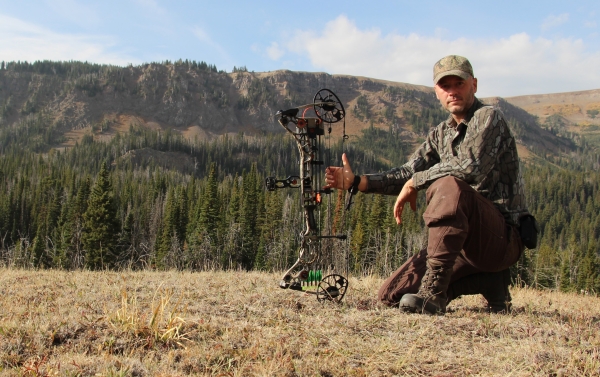 A bowhunter with his bow while in the mountains hunting