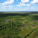 aerial view of swamp prairie with blue sky and clouds 
