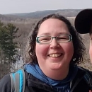 close-up photo of Pamela Skonberg with glasses and smiling.