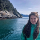 Carol Mahara smiles with the ocean and seaside in the background.
