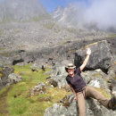 Jennie sits on a rock on a hiking trail in Hatchers Pass.