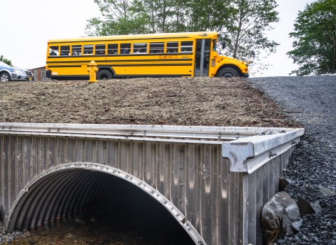 school bus passing over a fish passage culvert