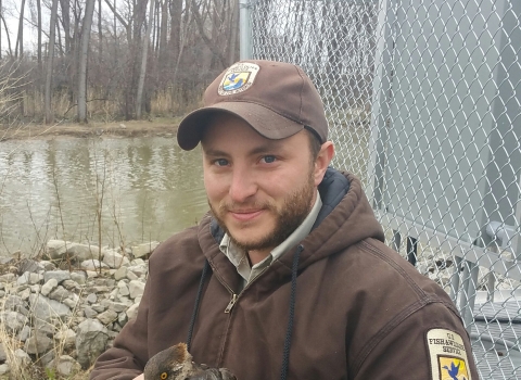 Jake Bonello is the assistant refuge manager at Julia Butler Hansen Refuge. In this photo he is holding a female hooded merganser (Lophodytes cucullatus). Photo Credit: Tyler Dolin