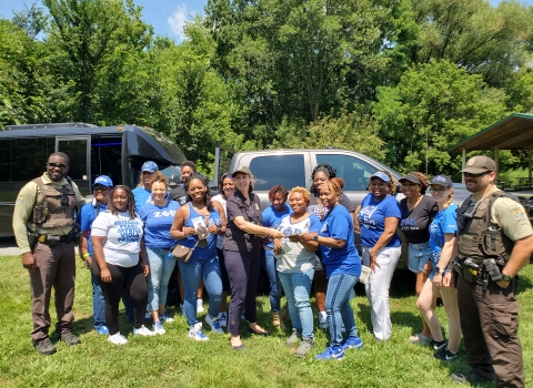 group stand outside, many wearing Zeta blue