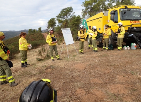 firefighters in circle around whiteboard