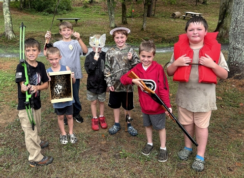 Children holding things they did at Wilderness Day Camp