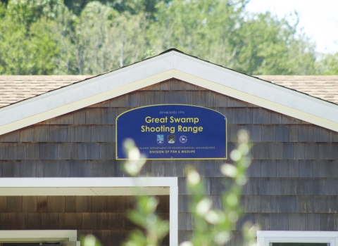 Blue welcome sign at over the shooting range